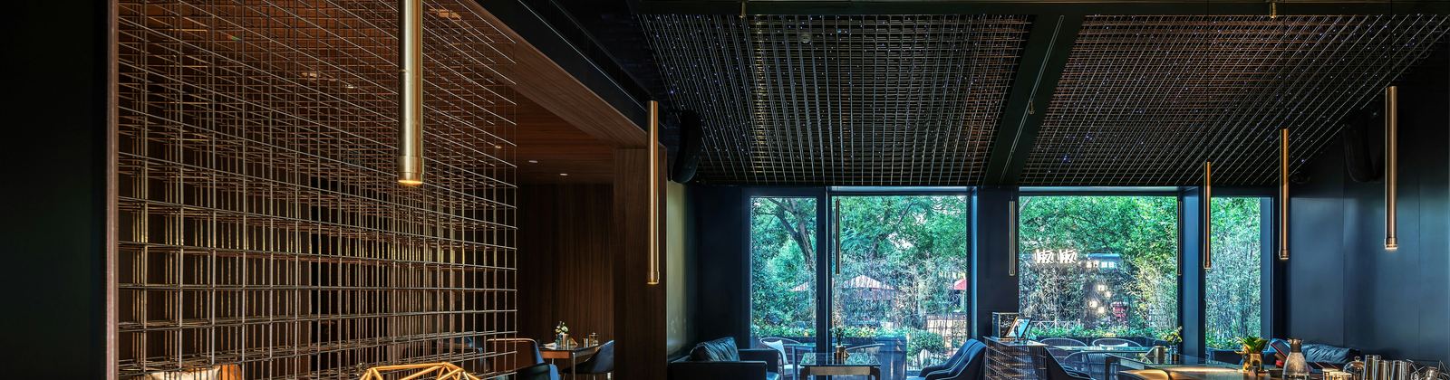 Restaurant dining room with warm timber and dark ceiling