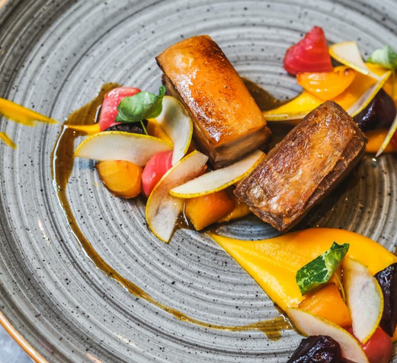 Plated roast pork with beetroot and squash purée